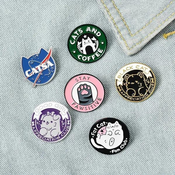 six pins with different designs on them sitting in the pocket of someone's jeans