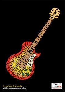 an electric guitar with words written on the body in different colors and sizes, including black background