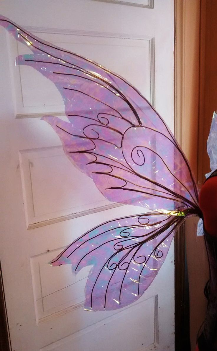 a purple fairy wings sitting on top of a door