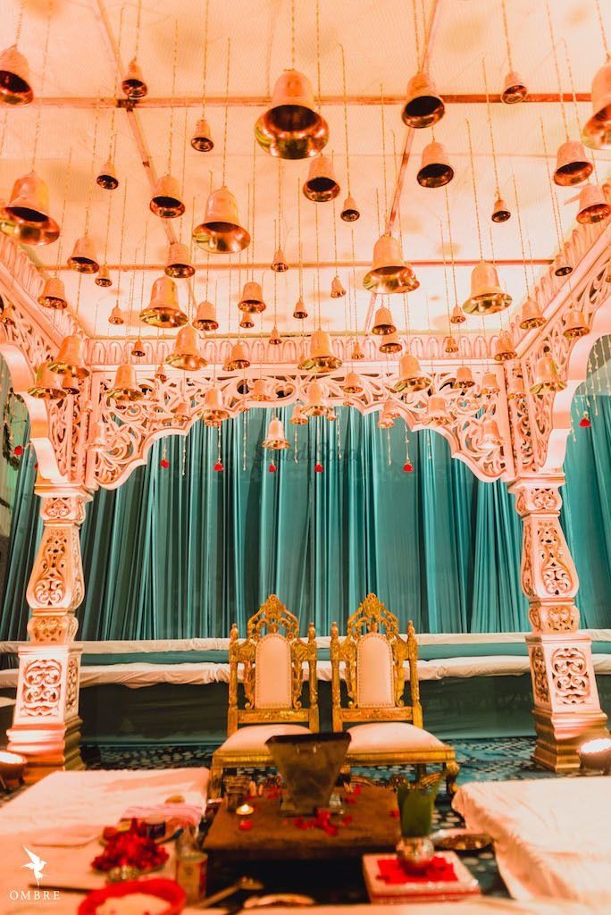 an elaborately decorated stage set up for a wedding ceremony with candles and flowers on the table