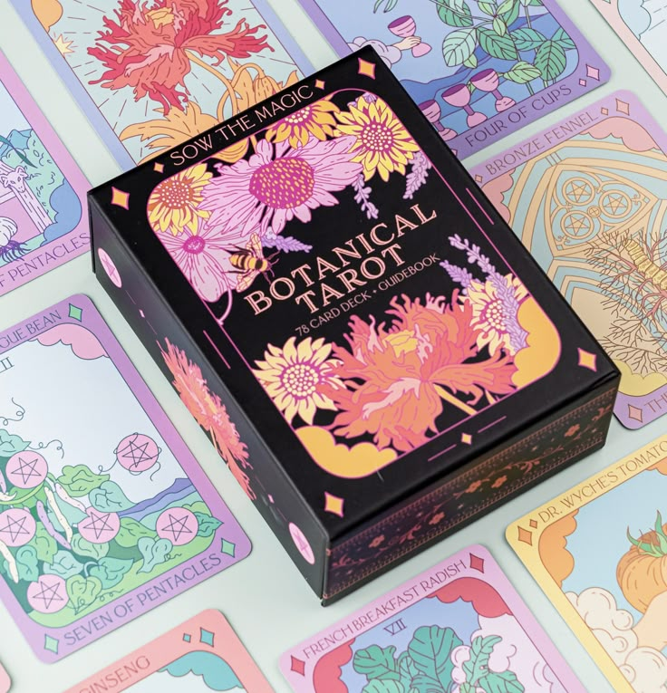 the box for botanical tarot is sitting on top of colorful cards