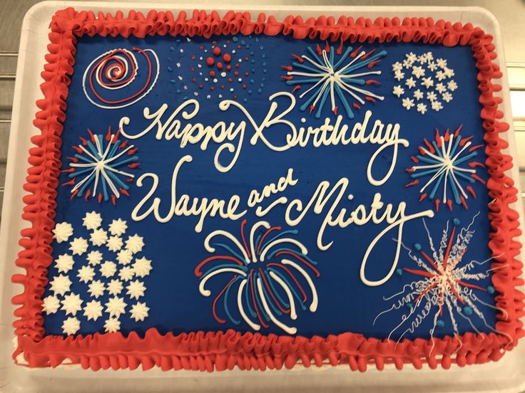 a blue and red birthday cake with fireworks on it