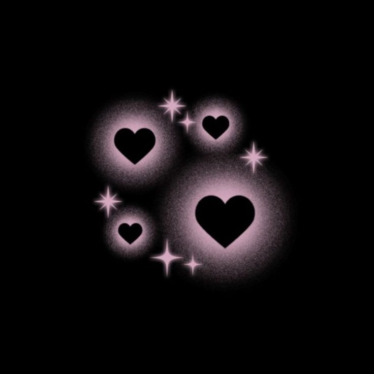 three hearts are glowing in the dark with stars around them and on top of each other