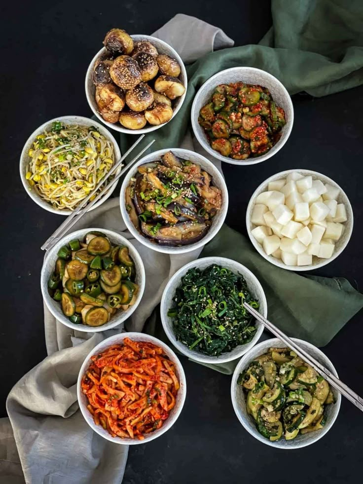 several bowls filled with different types of food