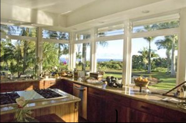 a kitchen with lots of windows overlooking the ocean