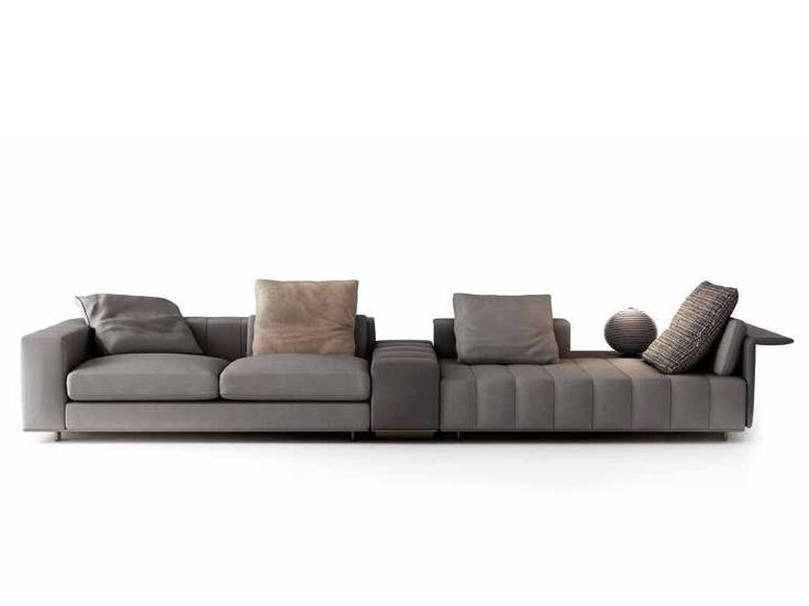 a gray couch with pillows on top of it