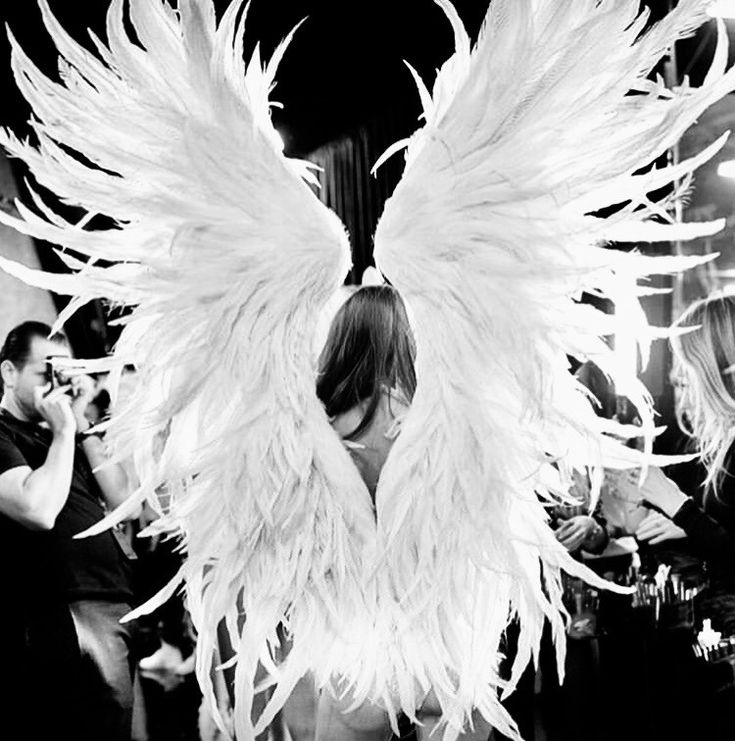 black and white photograph of woman with angel wings