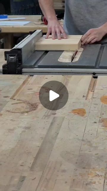 a man is using a table saw to cut planks on a piece of wood