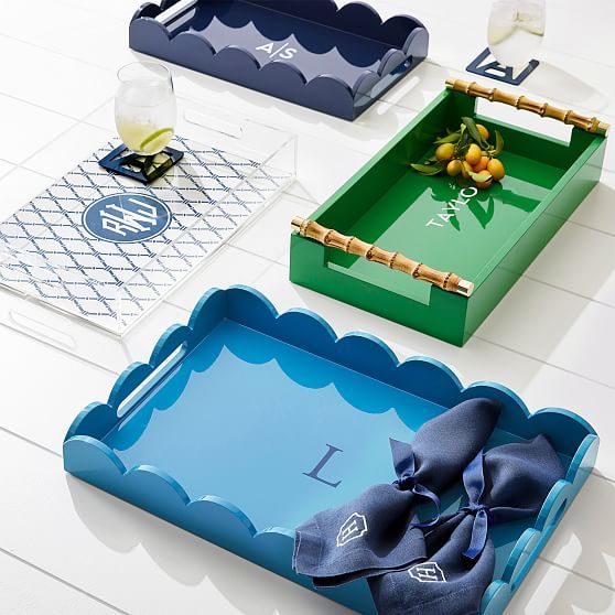 three serving trays with bows on them sitting on top of a white table next to each other