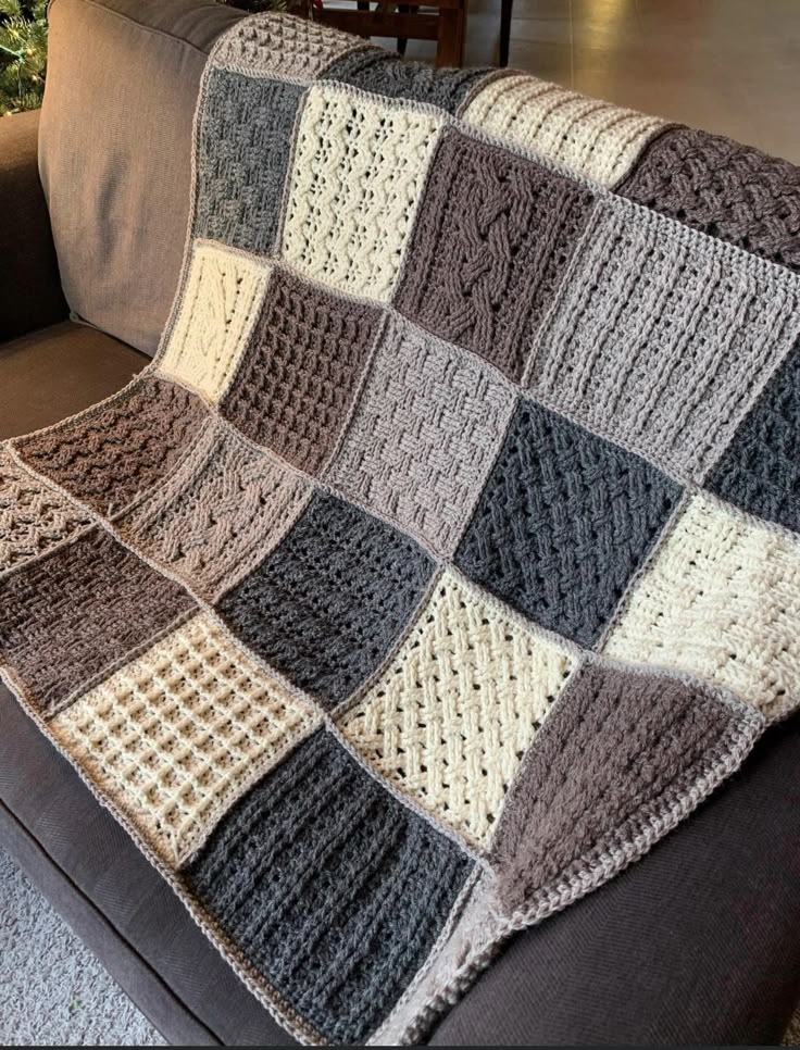 a crocheted blanket sitting on top of a couch