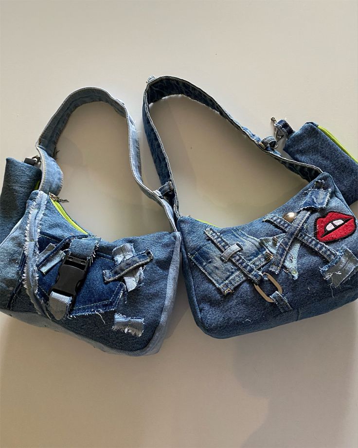 two pairs of blue jean shoes with red lips and zippers on the bottom, one pair is made out of old jeans