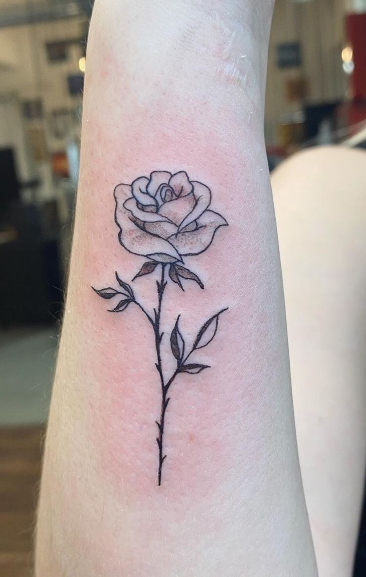 a small rose tattoo on the wrist