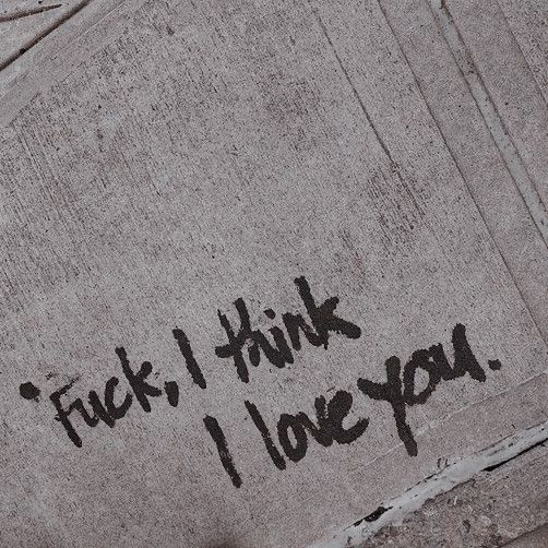 graffiti written on the side of a cement wall that says,'f k i think i love you '