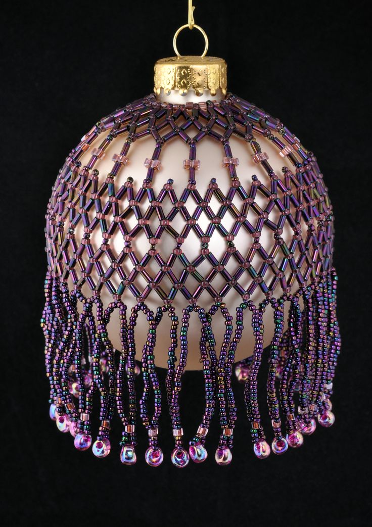 a glass ornament with beads hanging from it