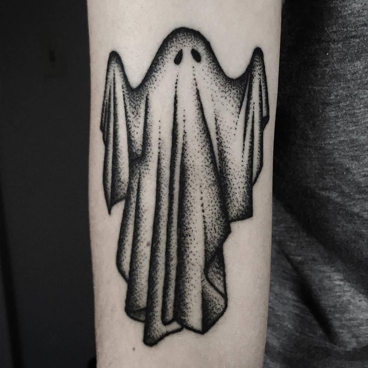 a black and white photo of a ghost tattoo