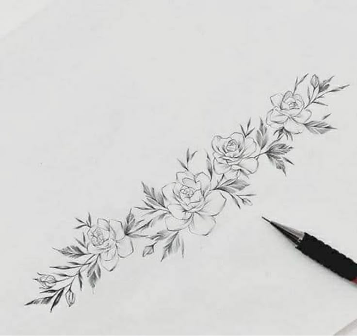 a pencil and some flowers on a sheet of paper