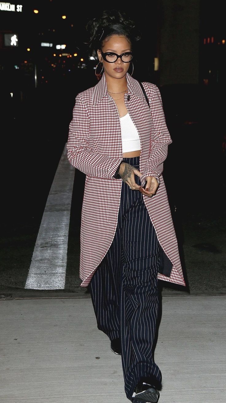 a woman wearing black and white checkered blazer, cropped pants and heels