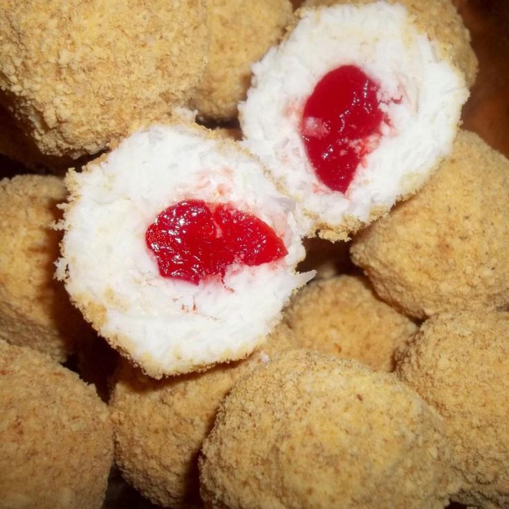 some kind of food that looks like sushi rolls with jelly on top and another type of meat in the middle