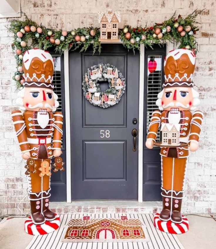 two large nutcrackers are standing in front of a door decorated for christmas