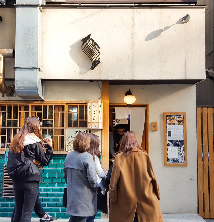 several people are standing in front of a building