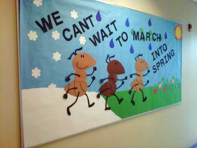 a bulletin board that says we can't wait to march into spring on the wall