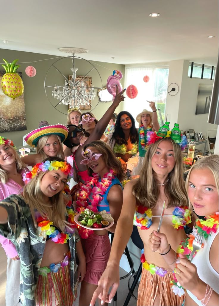 a group of women standing next to each other in front of a table filled with food