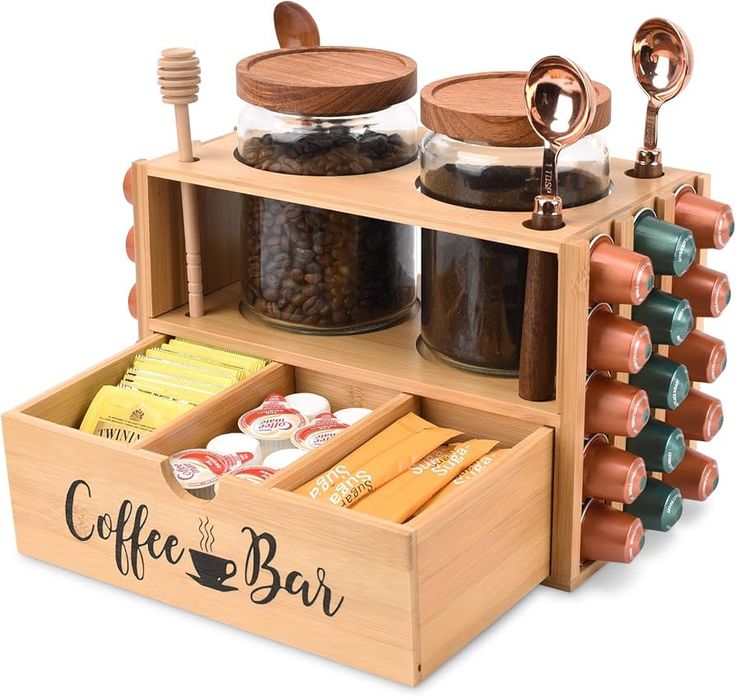 a wooden coffee bar with cups, spoons and other items in the tray on display