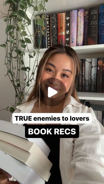 a woman sitting in front of a bookshelf with the words true emmies to lovers book recs