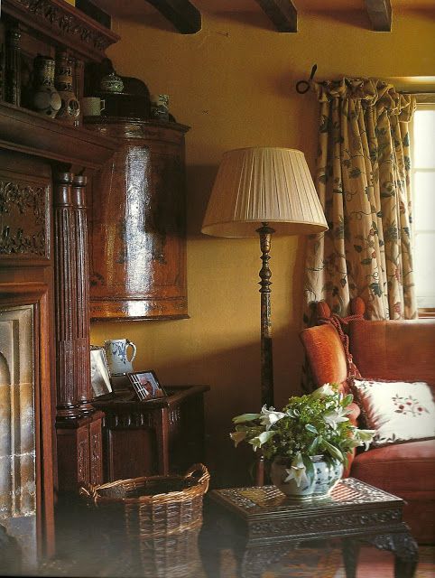 a living room filled with furniture and a fire place next to a lamp on top of a table