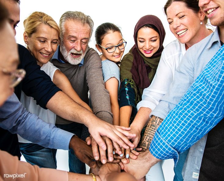 a group of people stacking their hands together in the middle of a huddle