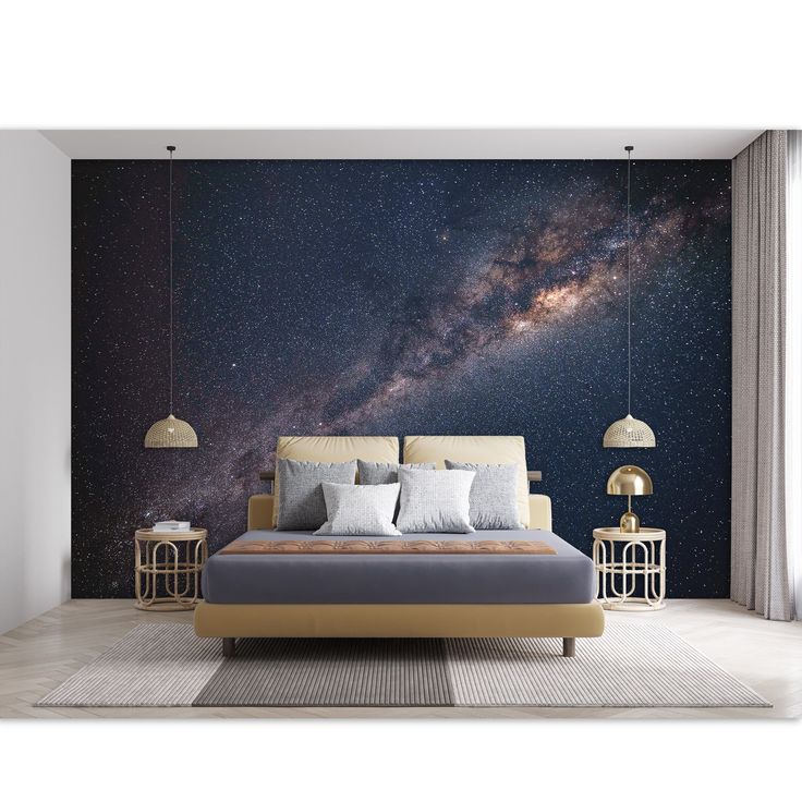 a bedroom with a large bed and night sky wall mural