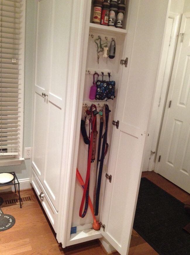 a white cabinet filled with lots of different types of umbrellas and other things in it