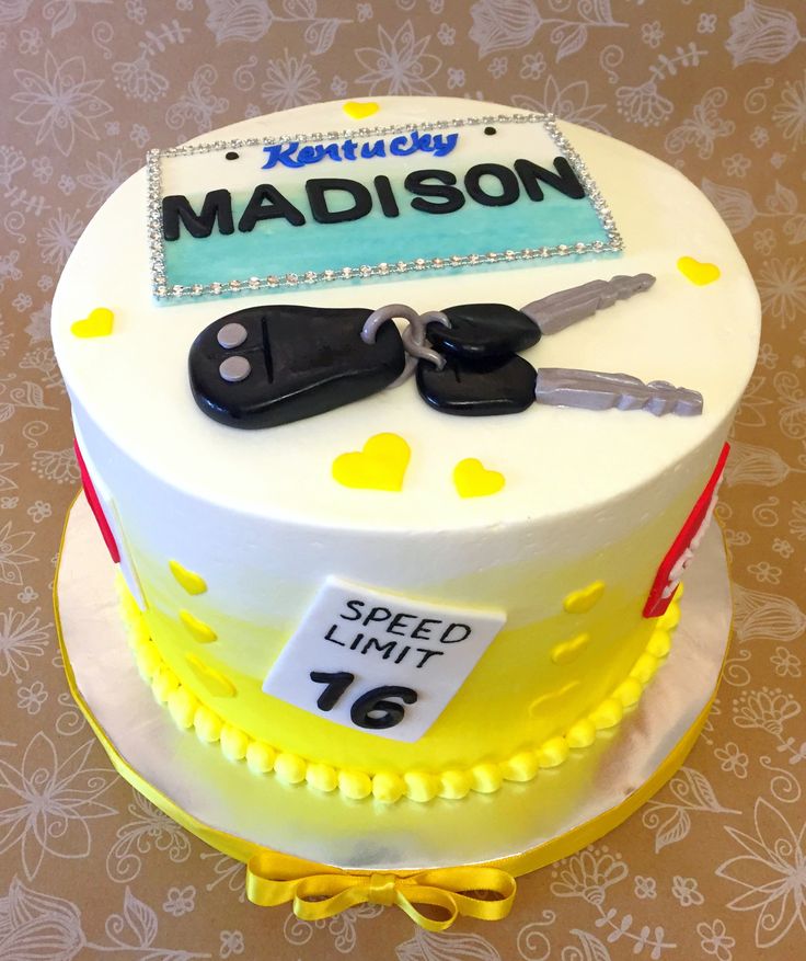 a birthday cake with two car keys and a name tag on it that says madison speed limit