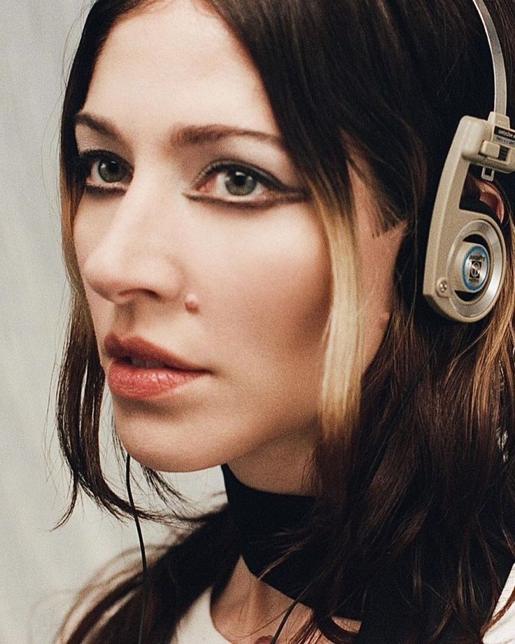 a woman with headphones on her ears