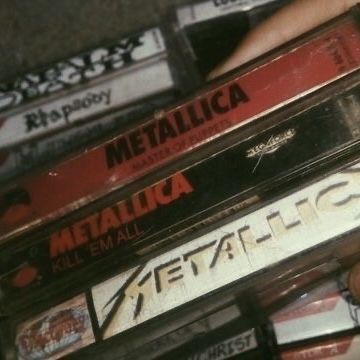 there are many cassettes stacked on top of each other in this pile, with the words metallic written on them