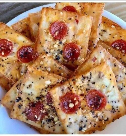 pepperoni and cheese crackers on a white plate