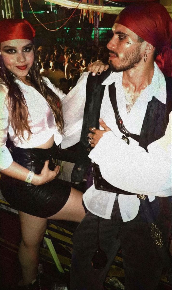 a man and woman dressed in pirate costumes