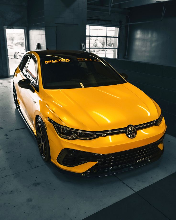 a yellow car is parked in a garage