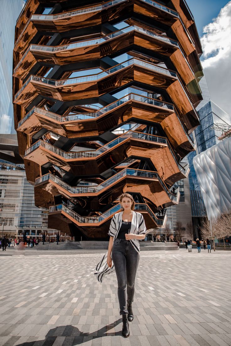 a woman standing in front of a building made out of wooden planks with the words instagram on it