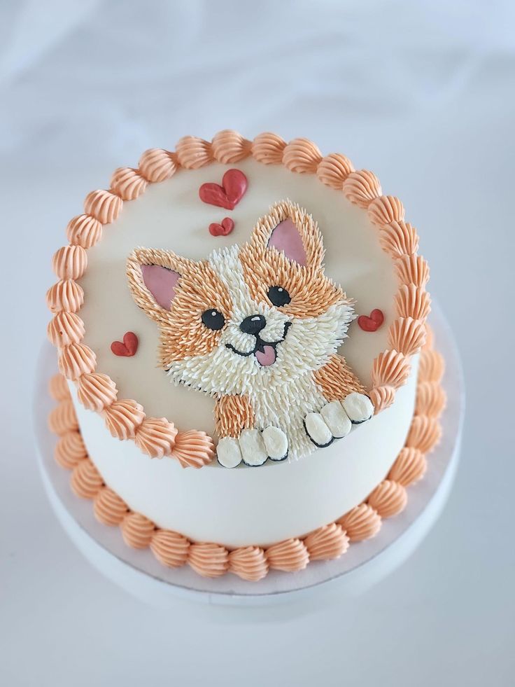 a cake decorated with an image of a dog on the side and hearts around it