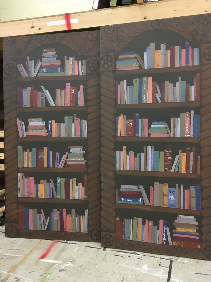 two large bookshelves are made out of wood and painted with different colors on them