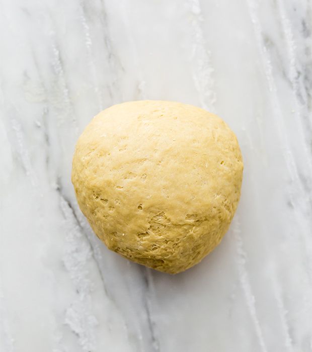 a ball of dough sitting on top of a marble counter