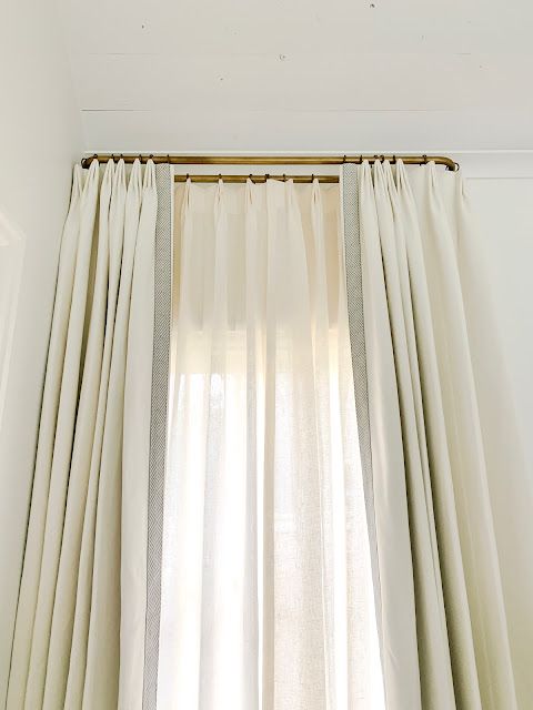 an open window with white curtains and light coming through