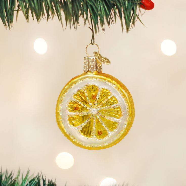 a yellow ornament hanging from a christmas tree