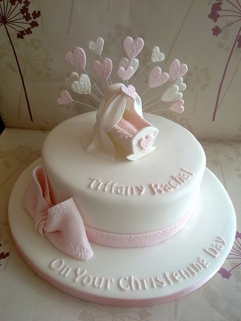 a white cake with pink decorations on top