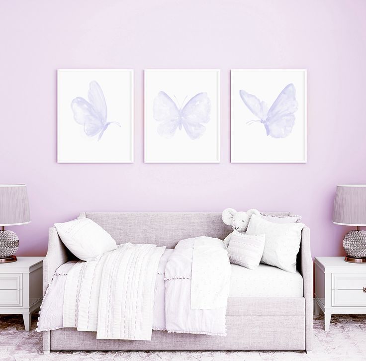 a bedroom with two paintings on the wall and a bed in the foreground,