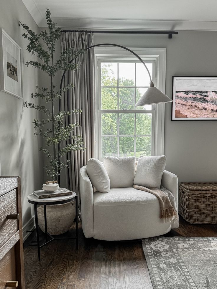 a living room filled with furniture and a lamp on top of a window sill