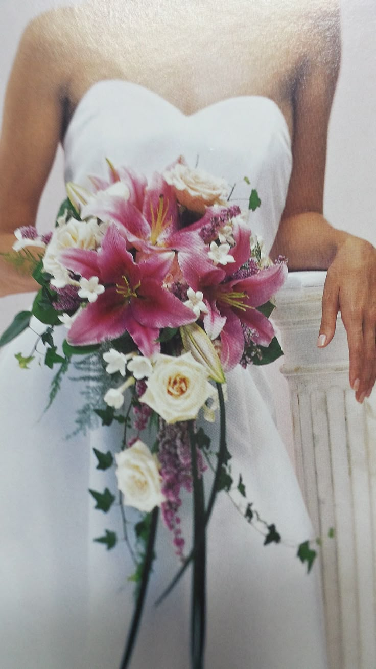 a bride holding a bouquet of flowers in her hand