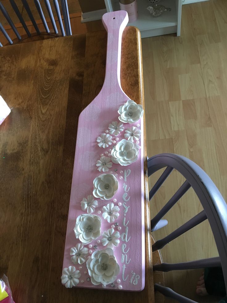 a wooden board with flowers painted on it