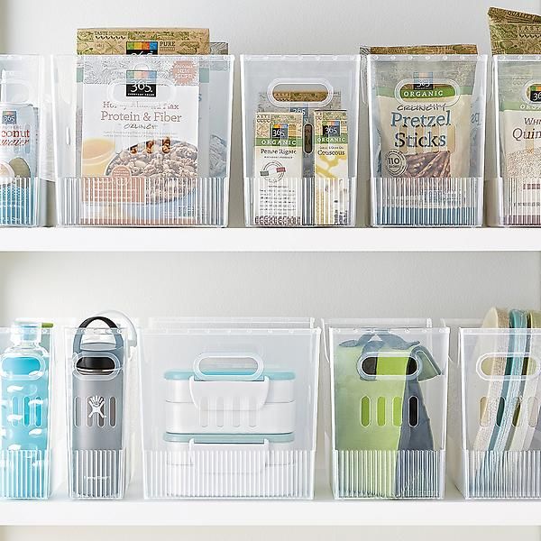 the shelves are filled with plastic containers and kitchen utensils for storing food items